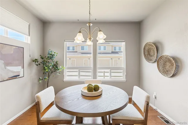 a view of a dining room with furniture and chandelier
