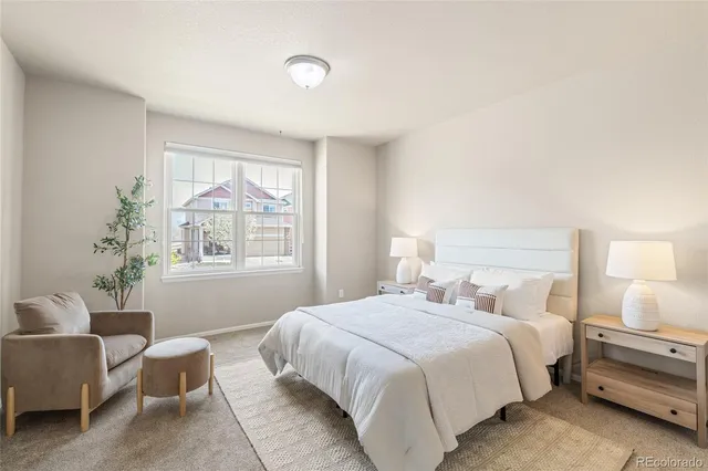 a bedroom with a bed and window