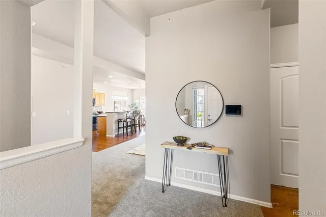 a bedroom with a bed a mirror and a window