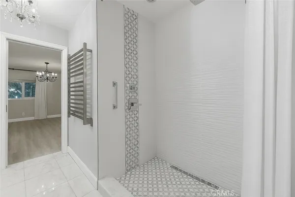 a view of a chandelier in big room and chandelier fan