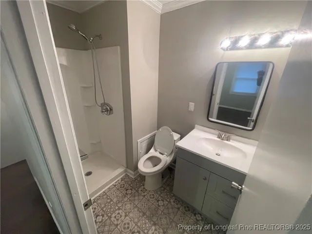 a bathroom with a sink and mirror with toilet