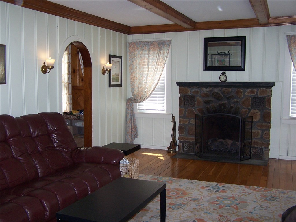 4 Diamond Hill Road Hopkinton, RI 02808 - Photo 16 of 40 living room also has hard wood ceiling beams, painted wood walls give a feeling of cozy... all rounded door ways and arches add a flare of art