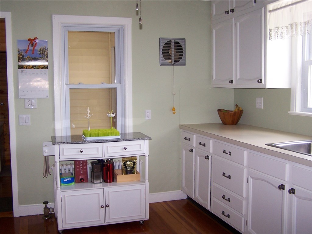 4 Diamond Hill Road Hopkinton, RI 02808 - Photo 24 of 40 looking into kitchen from the dining room. Bathroom and entry to basement to the left...window straight ahead looks into a small exit area to the back yard...