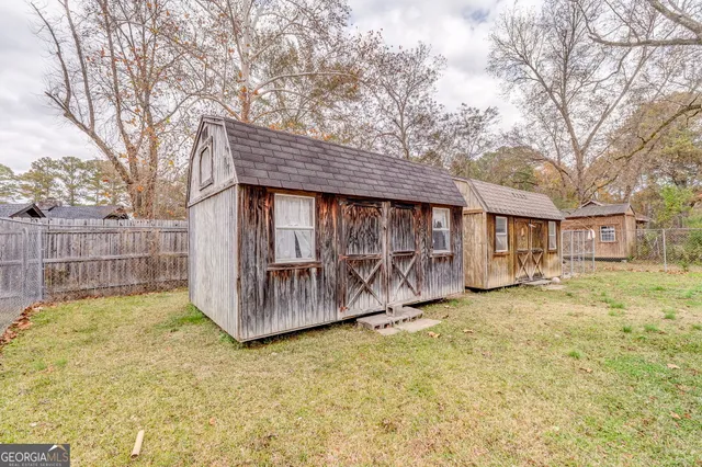 a view of a house with a big yard and large tree