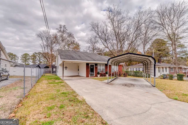 a front view of house with yard covered in snow
