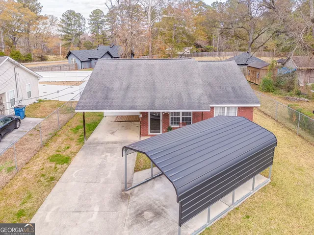 a view of a patio with table and chairs with wooden floor and fence