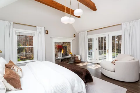 a spacious bedroom with a bed and glass window