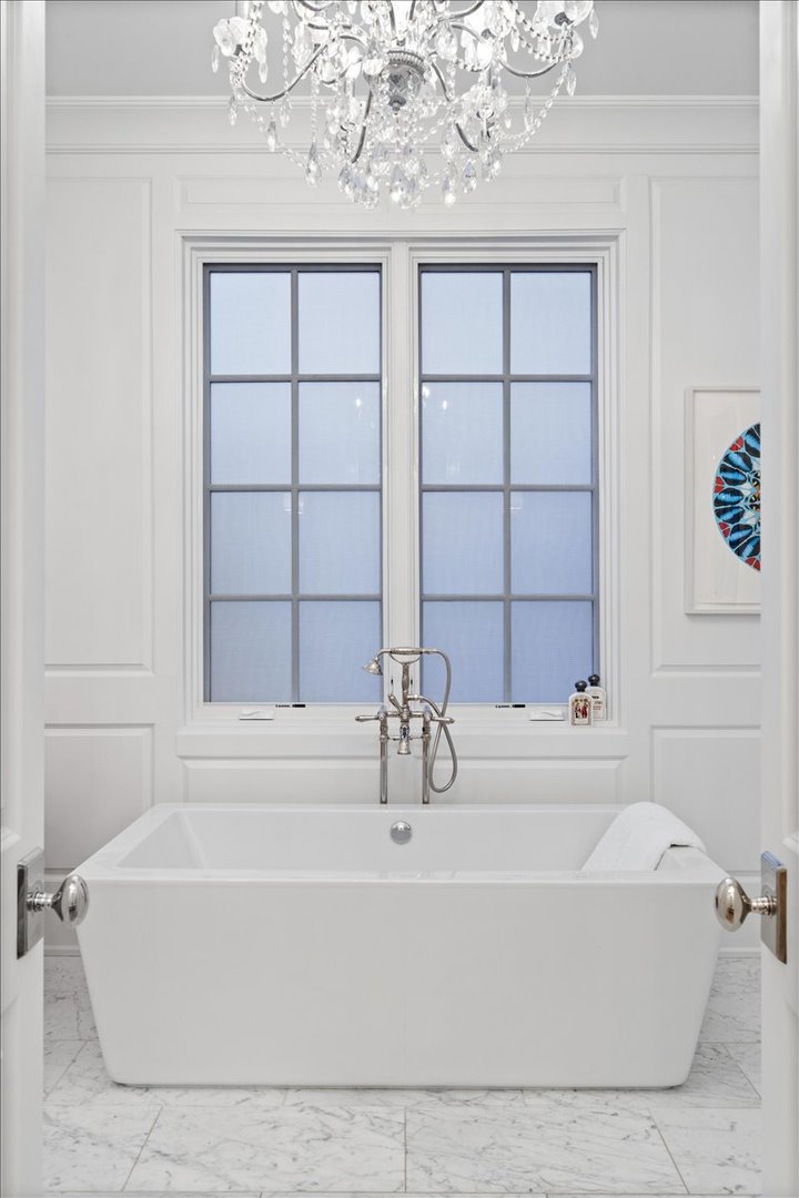 2633 North Dayton Street Chicago, IL 60614 - Photo 23 of 43 a white bath tub sitting next to a window