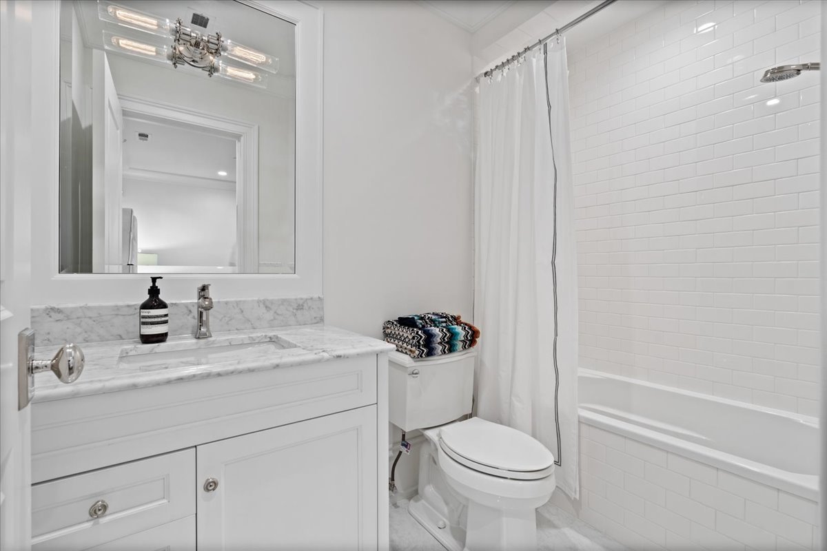 2633 North Dayton Street Chicago, IL 60614 - Photo 31 of 43 a bathroom with a sink a toilet a mirror and shower