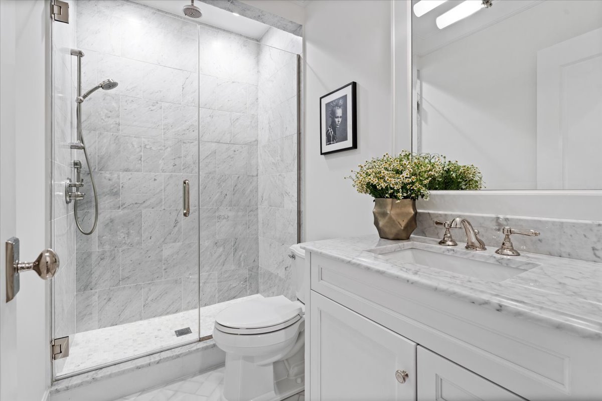 2633 North Dayton Street Chicago, IL 60614 - Photo 36 of 43 a bathroom with a granite countertop sink a toilet and shower