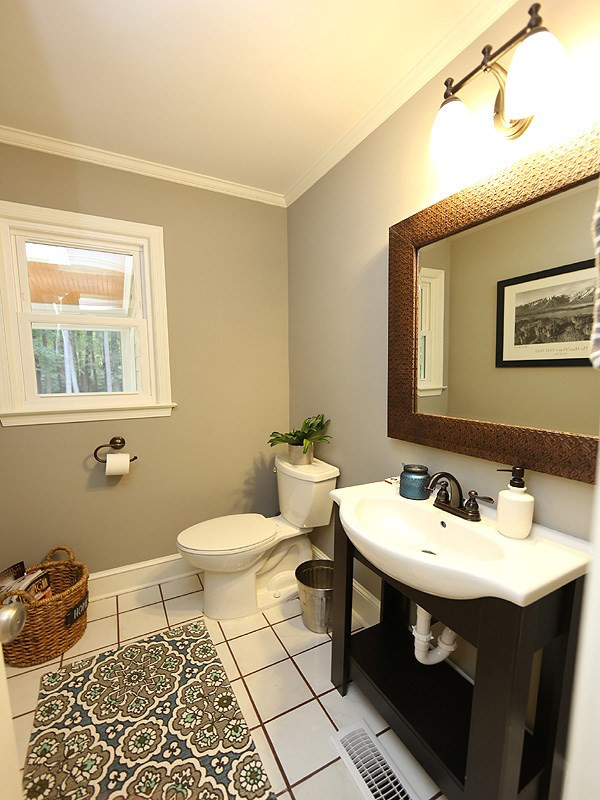 8320 Wheatstone Lane Raleigh, NC 27613 - Photo 12 of 23 Cute 1/2 Bathroom is cleaverly tucked between the Kitchen and the Living Room, across from an oversized storage closet. Powder Room