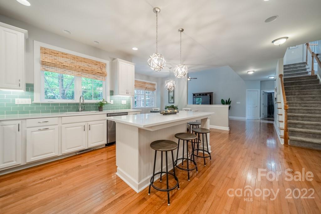 9622 Baileywick Road Charlotte, NC 28277 - Photo 13 of 39 a large kitchen with a wooden floor and cabinets