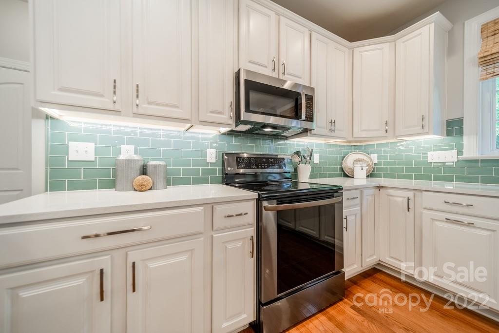 9622 Baileywick Road Charlotte, NC 28277 - Photo 14 of 39 a kitchen with white cabinets and appliances