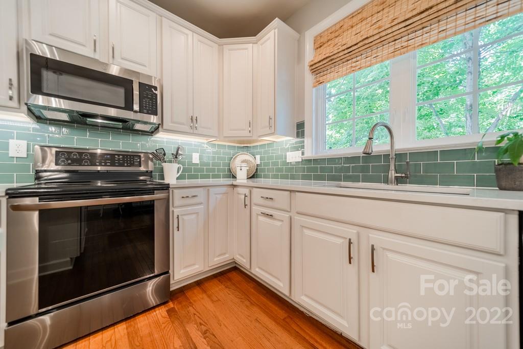 9622 Baileywick Road Charlotte, NC 28277 - Photo 15 of 39 a kitchen with stainless steel appliances granite countertop white cabinets granite counter tops and a window