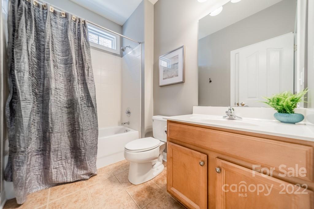 9622 Baileywick Road Charlotte, NC 28277 - Photo 19 of 39 a bath room with a toilet a sink and a bath tub