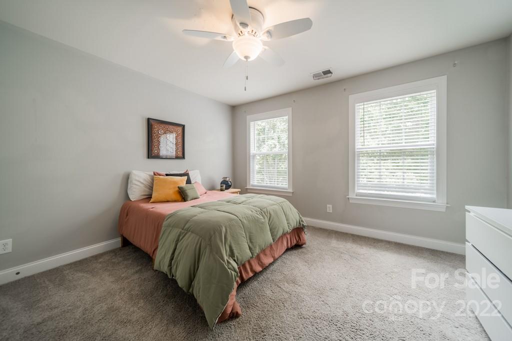 9622 Baileywick Road Charlotte, NC 28277 - Photo 25 of 39 a spacious bedroom with a bed and a window
