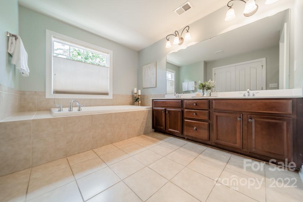 9622 Baileywick Road Charlotte, NC 28277 - Photo 30 of 39 a bathroom with a sink mirror vanity and bathtub