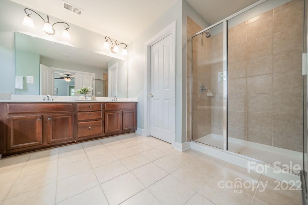9622 Baileywick Road Charlotte, NC 28277 - Photo 31 of 39 a spacious bathroom with a mirror a shower and a sink