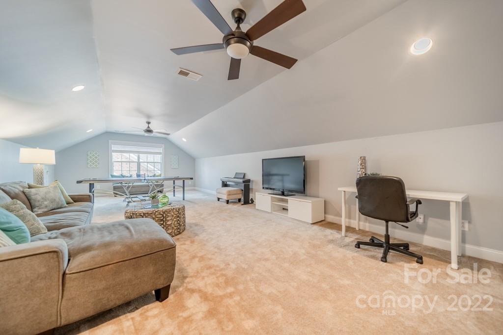 9622 Baileywick Road Charlotte, NC 28277 - Photo 32 of 39 a living room with furniture a window and a flat screen tv