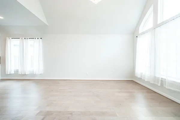 a spacious bathroom with a tub sink shower and mirror