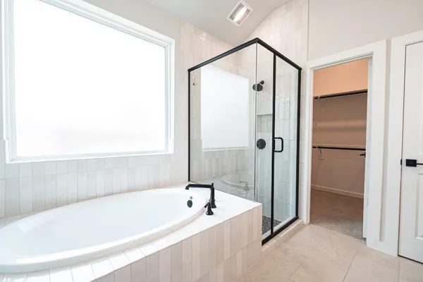 a bathroom with a bathtub and shower
