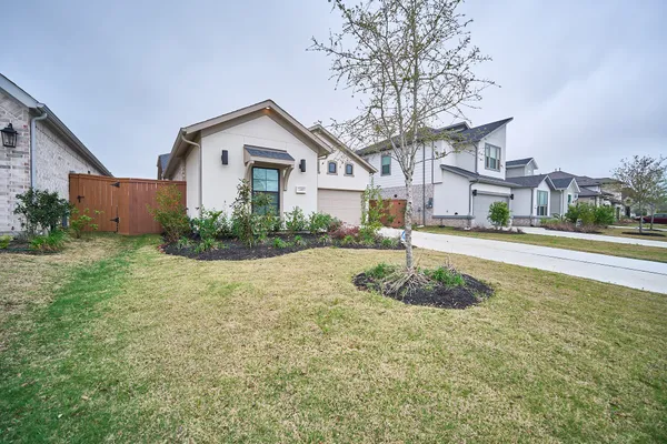 a white house that has a tree in front of it