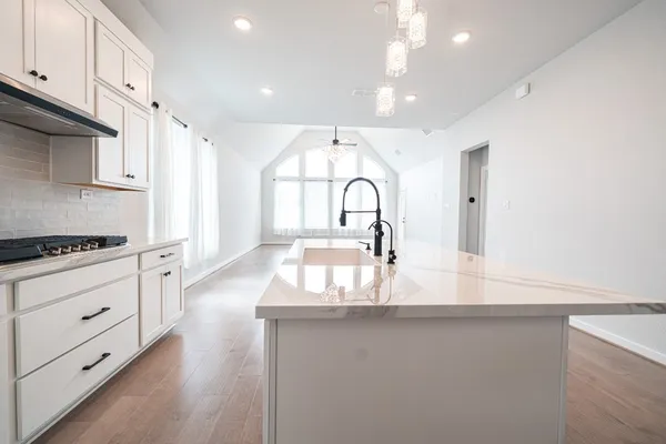 an empty room with wooden floor window and ceiling fan