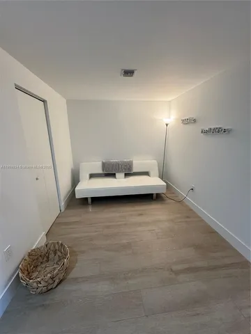 a view of a livingroom with furniture and white walls