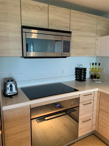 a kitchen with a cabinets and a stove top oven