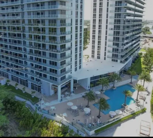 a view of a backyard with plants and outdoor seating