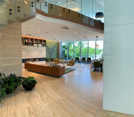 a lobby with furniture and a potted plant