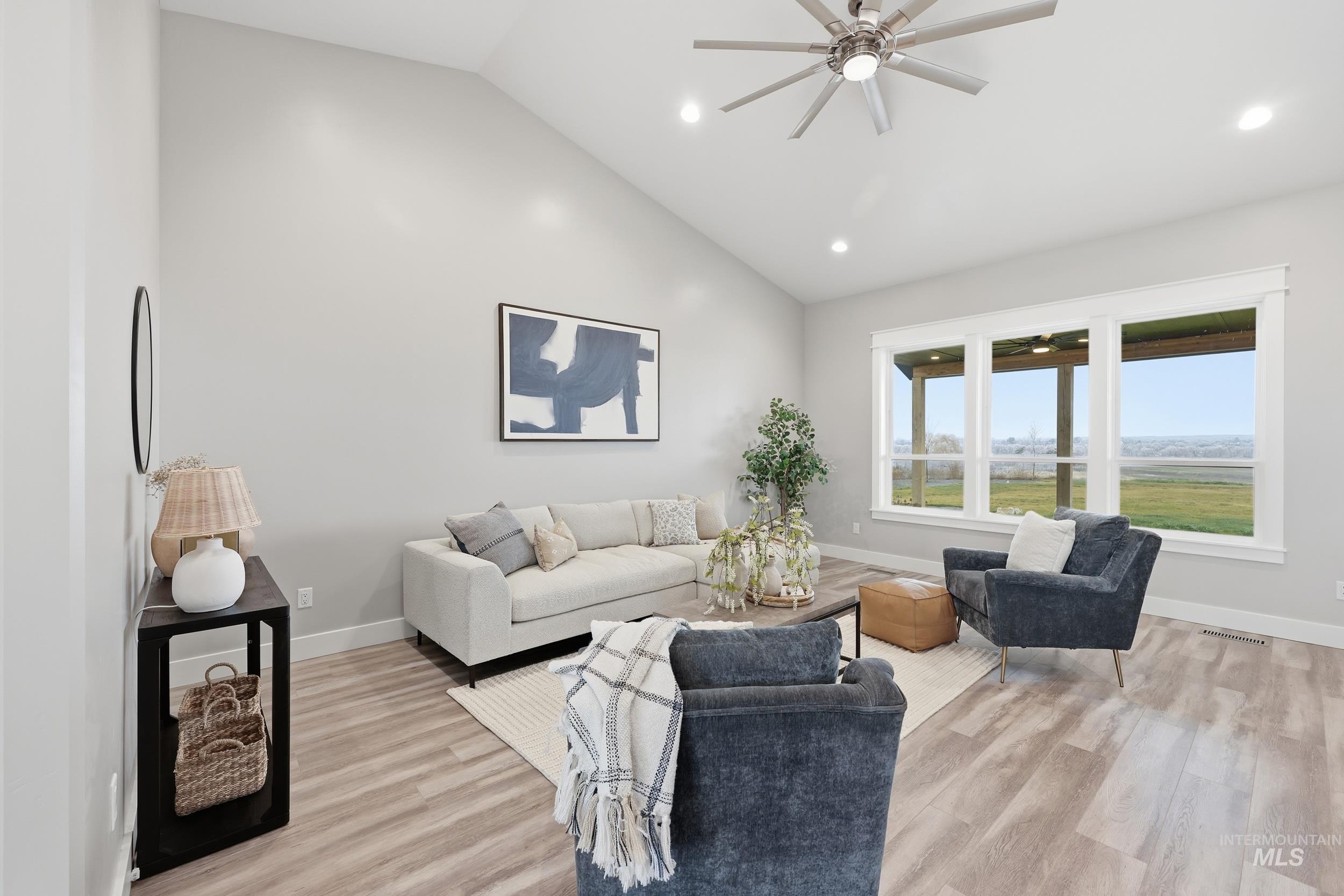 9264 Basin Kid Court Middleton, ID 83644 - Photo 16 of 50 Living room with ceiling fan, light wood-style floors, and high vaulted ceiling