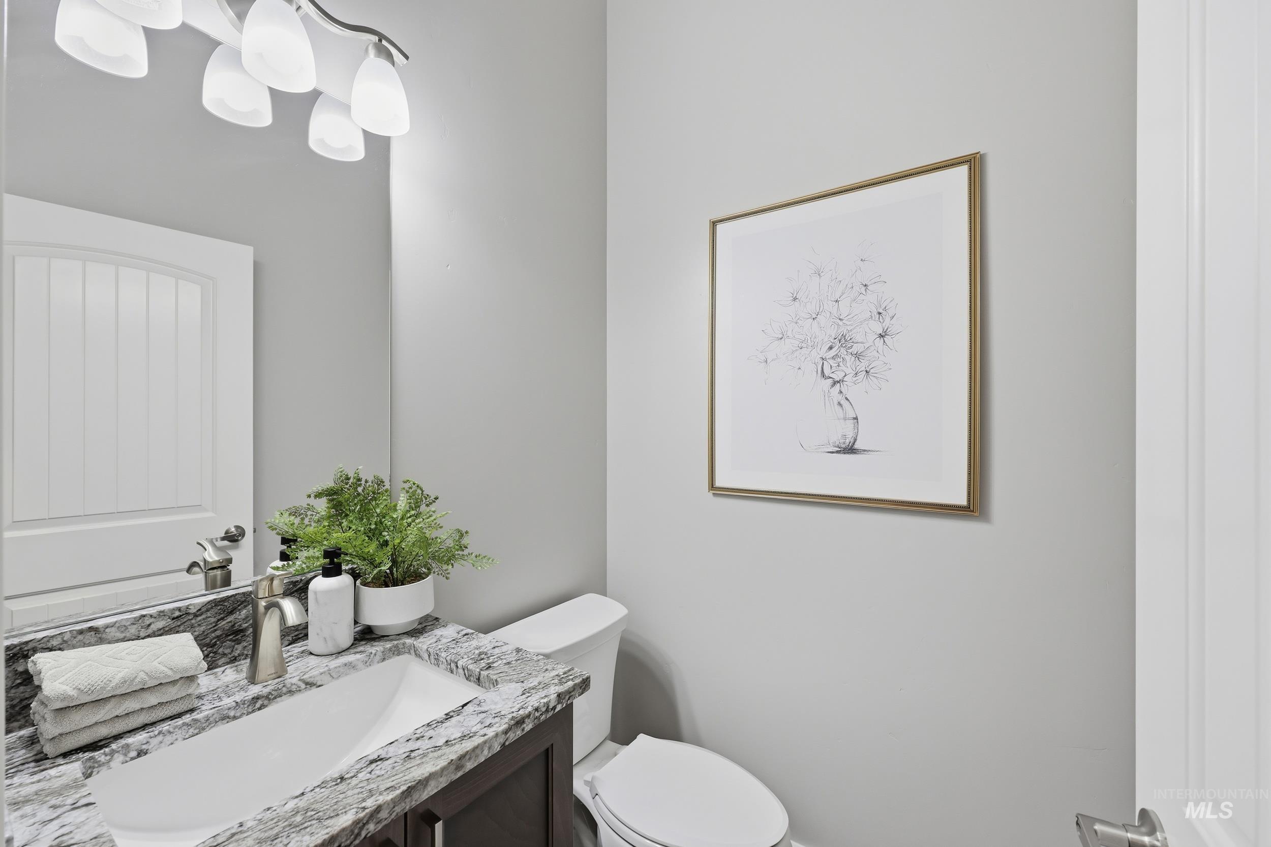9264 Basin Kid Court Middleton, ID 83644 - Photo 31 of 50 Half bathroom featuring vanity and a chandelier