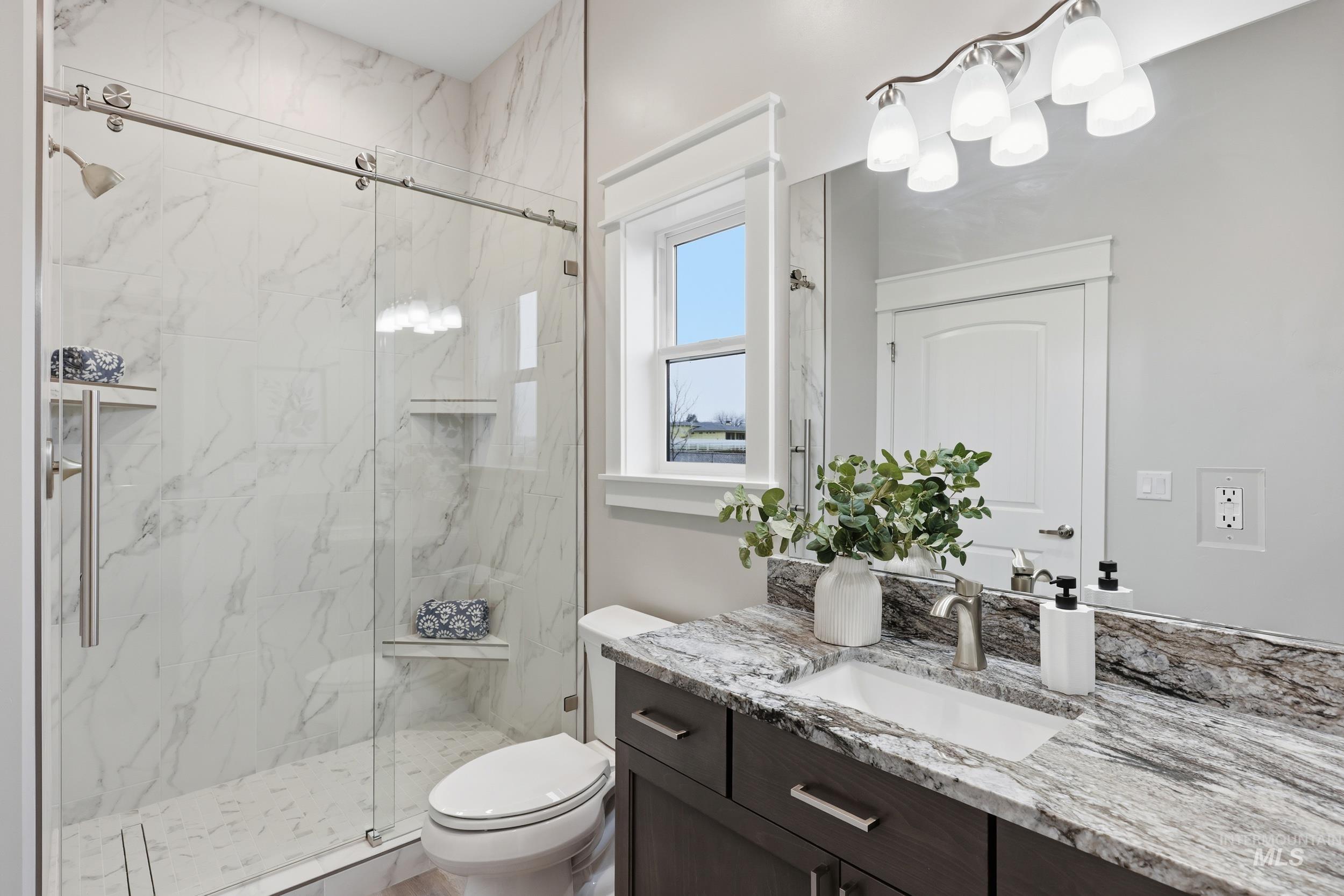 9264 Basin Kid Court Middleton, ID 83644 - Photo 34 of 50 Bathroom with vanity and a marble finish shower