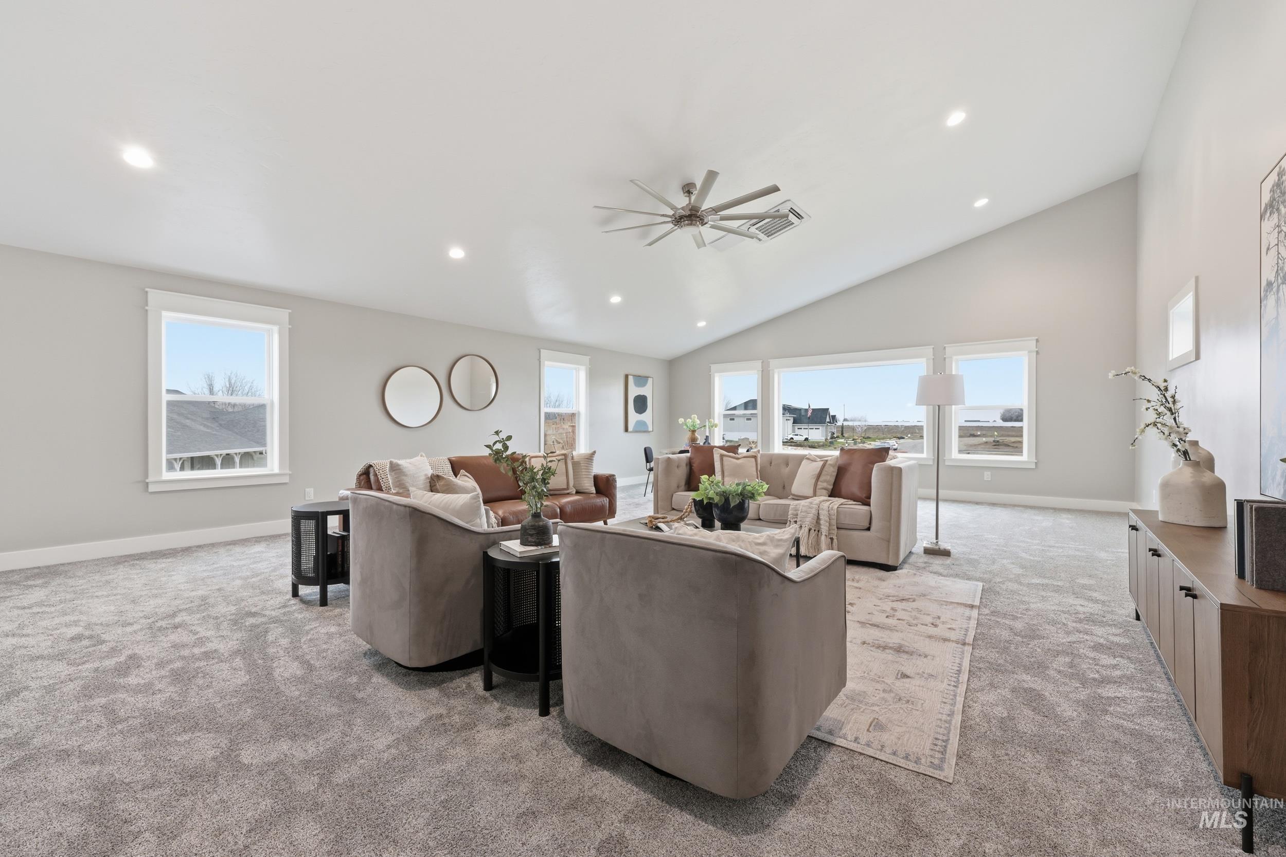 9264 Basin Kid Court Middleton, ID 83644 - Photo 41 of 50 Living area with light colored carpet, lofted ceiling, ceiling fan, and recessed lighting