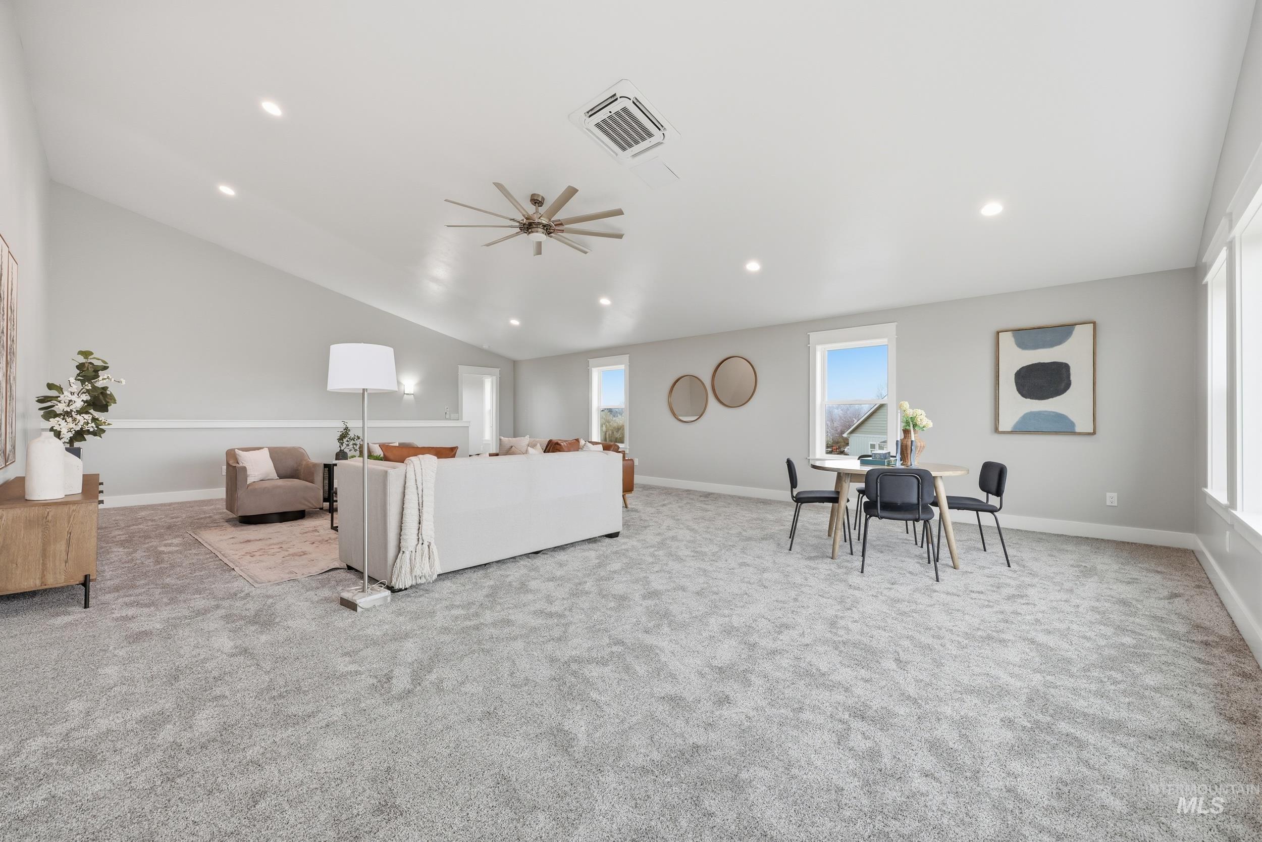 9264 Basin Kid Court Middleton, ID 83644 - Photo 42 of 50 Living area with vaulted ceiling, light colored carpet, cooling unit, ceiling fan, and recessed lighting