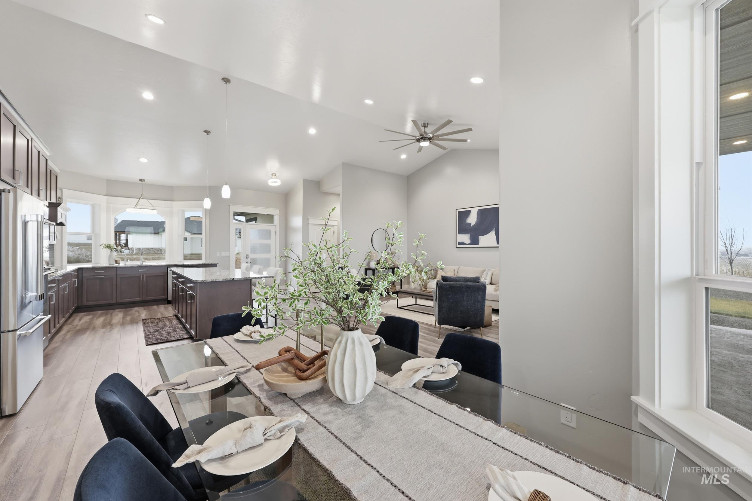 9264 Basin Kid Court Middleton, ID 83644 - Photo 8 of 50 Dining space featuring a ceiling fan, light wood-style flooring, vaulted ceiling, and recessed lighting