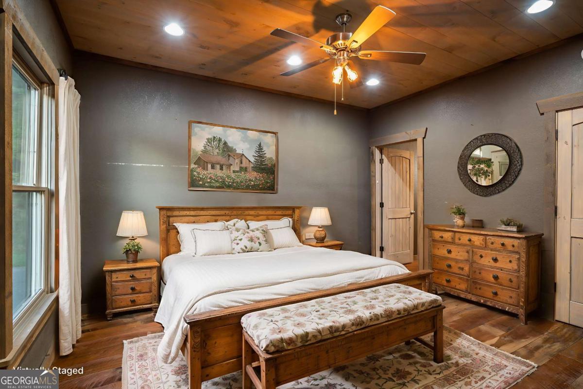 2637 River Road Mineral Bluff, GA 30559 - Photo 14 of 69 a bedroom with a bed a chandelier and a closet