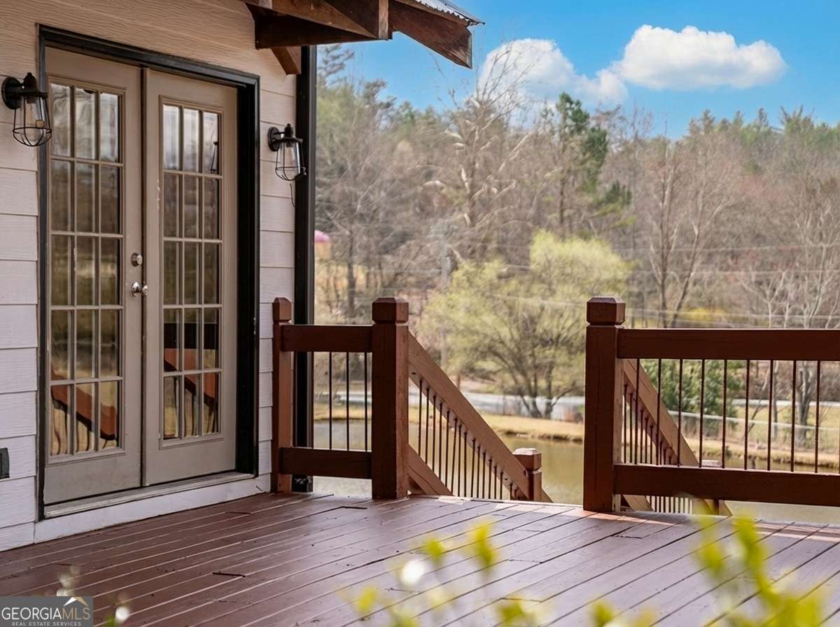 2637 River Road Mineral Bluff, GA 30559 - Photo 2 of 69 a view of a balcony with furniture and wooden floor