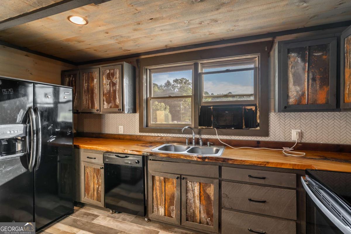 2637 River Road Mineral Bluff, GA 30559 - Photo 28 of 69 a kitchen with stainless steel appliances granite countertop a sink stove and refrigerator