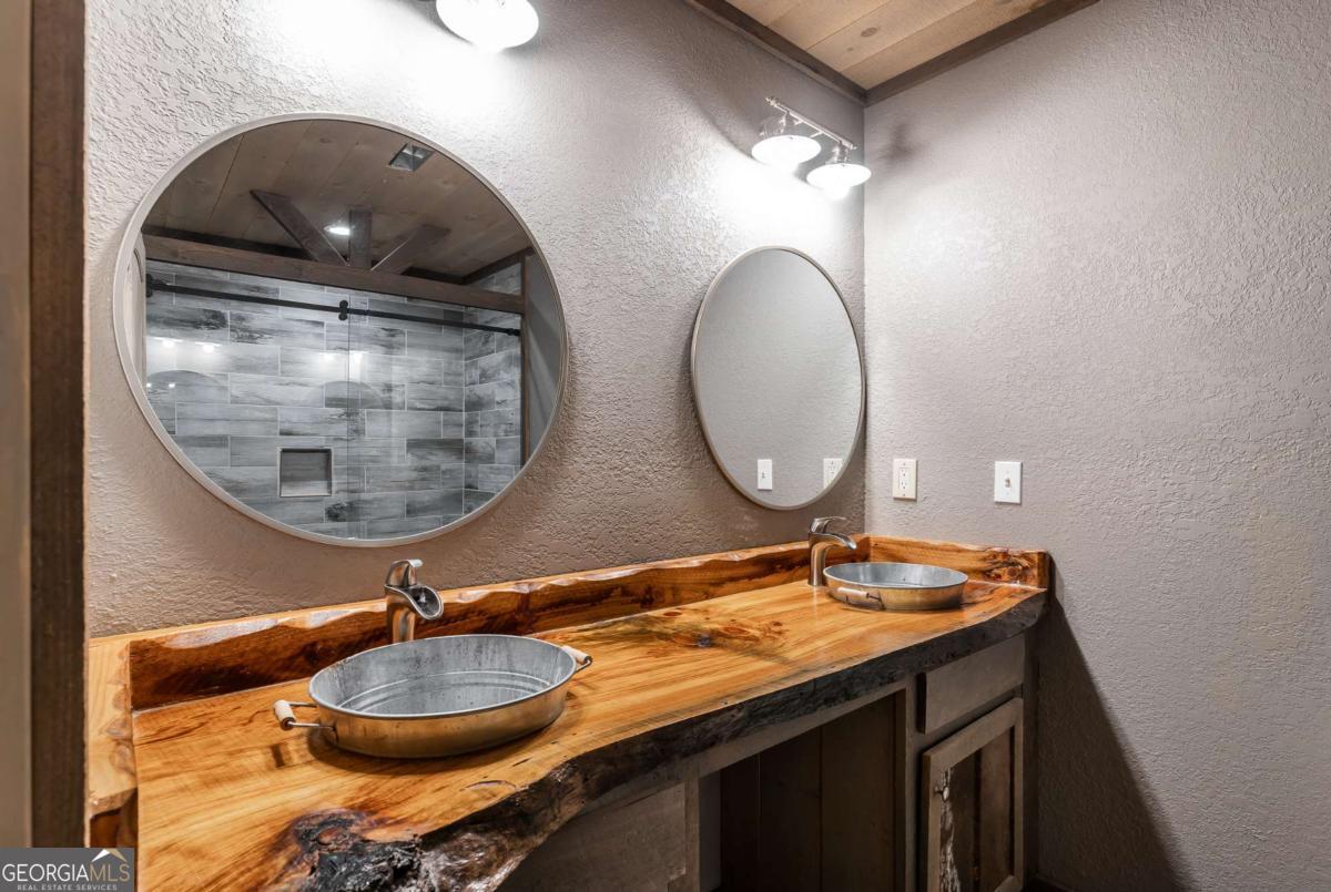 2637 River Road Mineral Bluff, GA 30559 - Photo 38 of 69 a bathroom with a granite countertop sink and a mirror