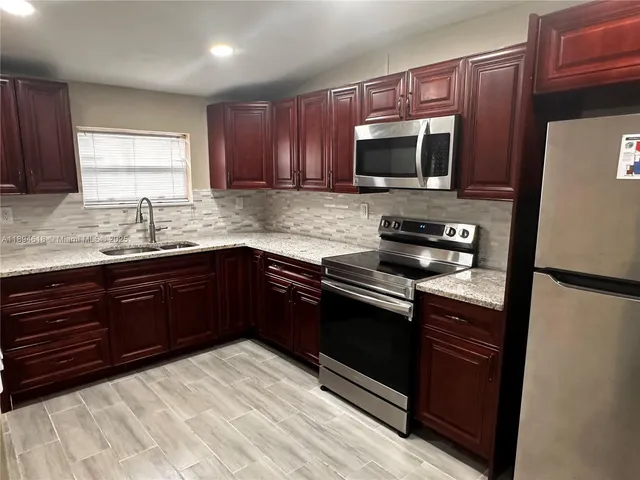 a kitchen with a sink stove and microwave