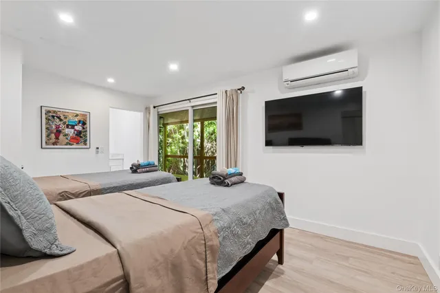 a bedroom with a bed and a large window