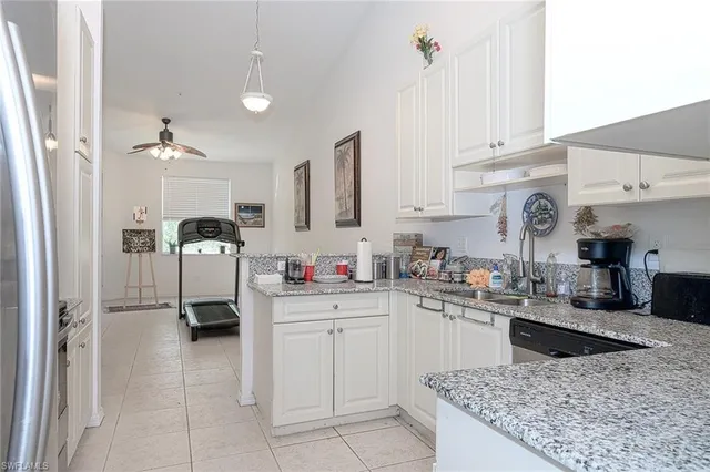 a kitchen with cabinets and window
