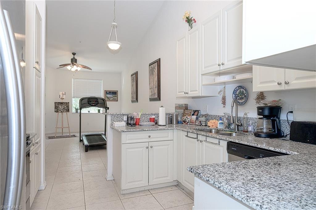 2930 37th Avenue Northeast Naples, FL 34120 - Photo 7 of 8 a kitchen with cabinets and window