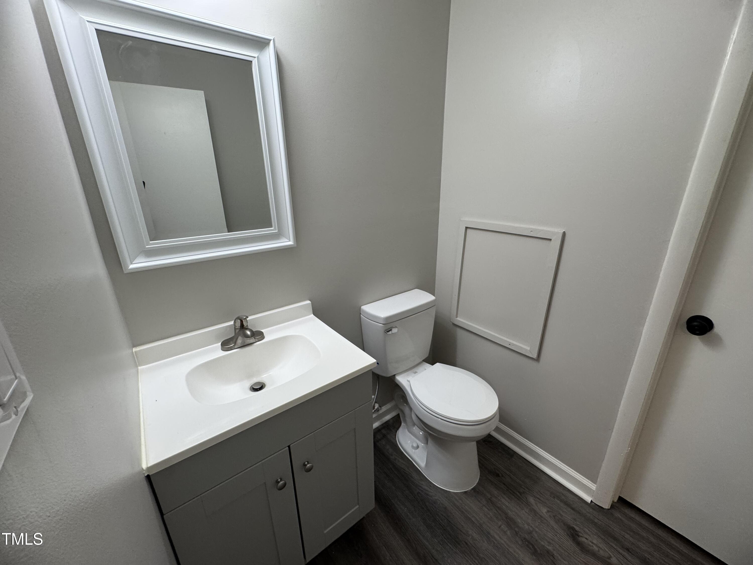 1222 Teakwood Place Raleigh, NC 27606 - Photo 12 of 15 a bathroom with a toilet sink and mirror