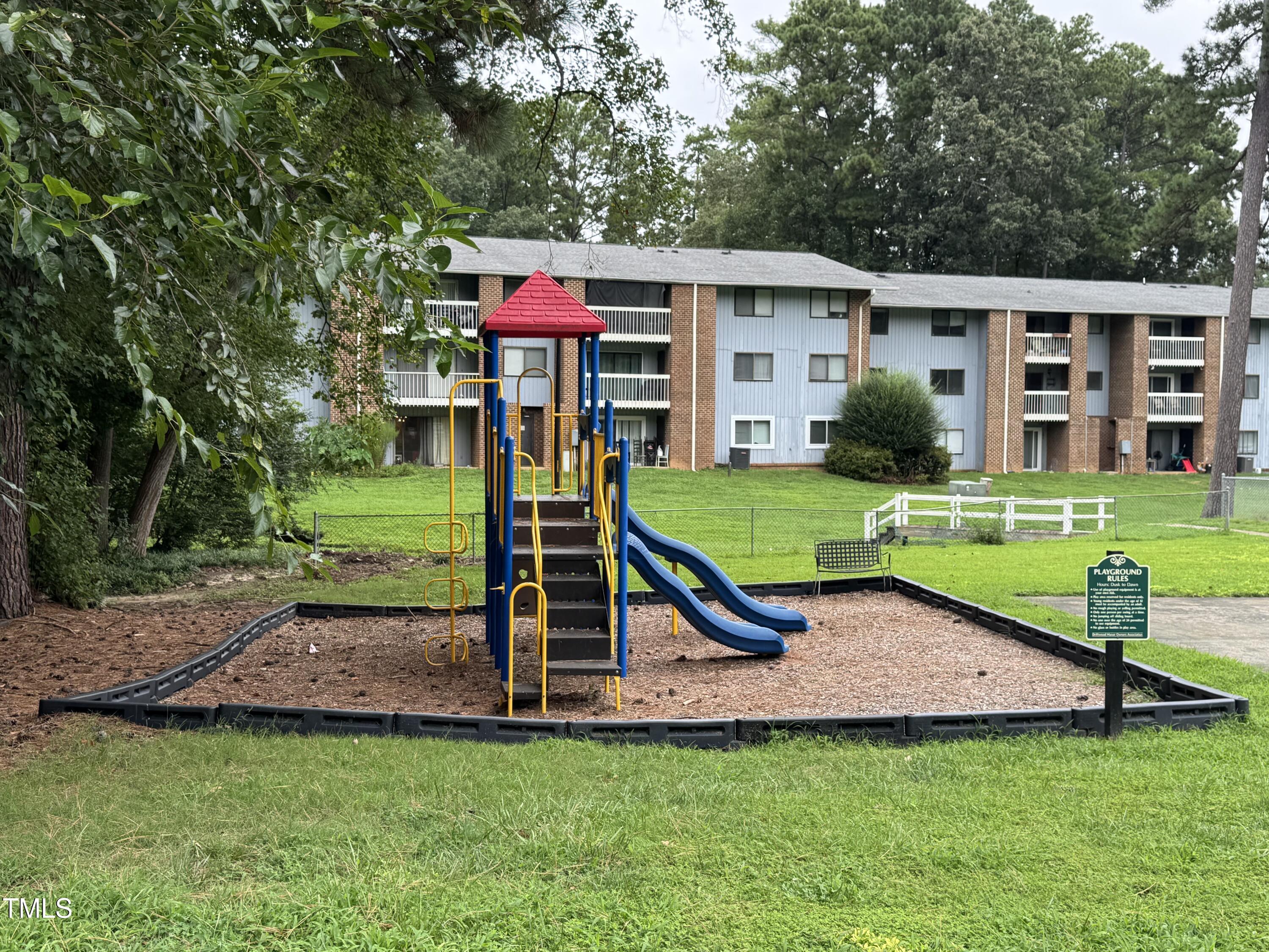 1222 Teakwood Place Raleigh, NC 27606 - Photo 14 of 15 a view of a house with a yard porch and sitting area