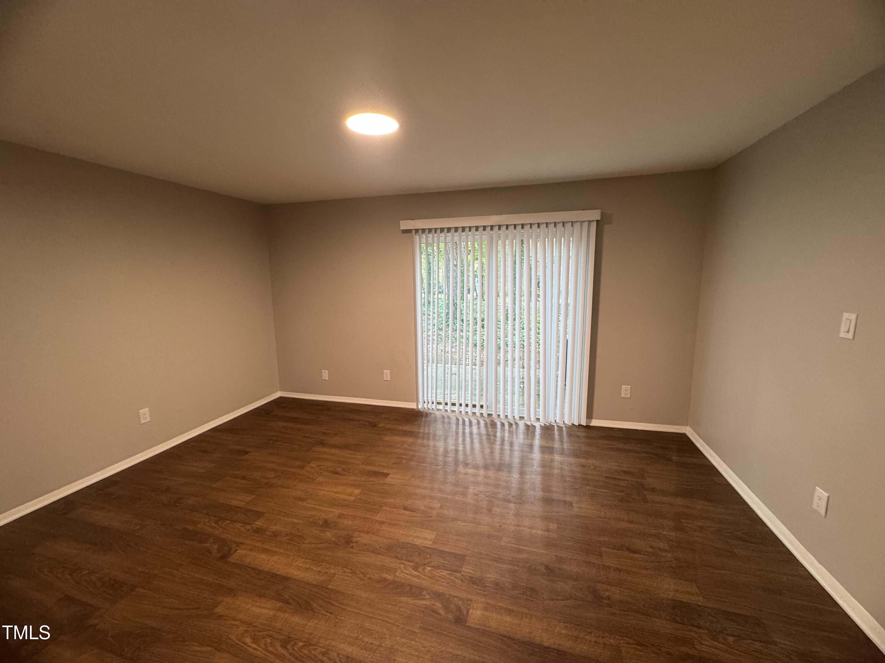 1222 Teakwood Place Raleigh, NC 27606 - Photo 4 of 15 wooden floor in an empty room with a window