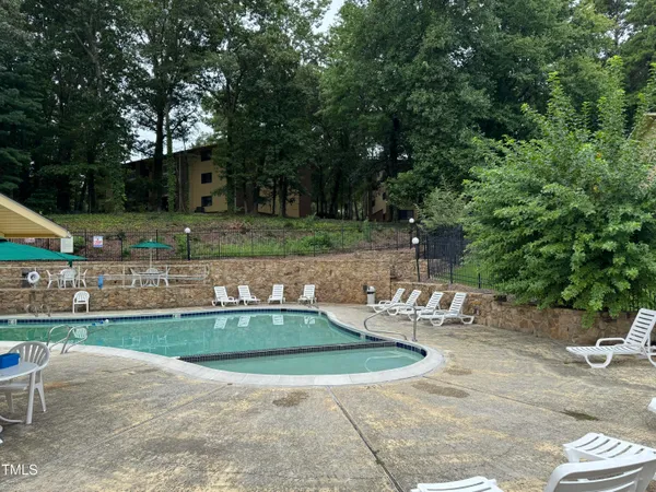a view of a house with backyard sitting area and garden