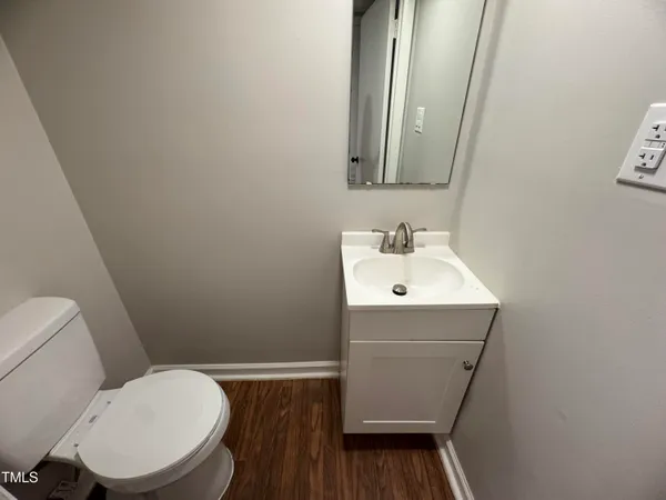 a bathroom with a sink toilet and mirror